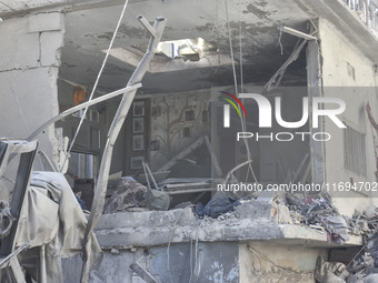 Civilians, paramedics, and Civil Defense Search and Rescue teams conduct search and rescue operations among the rubble of collapsed building...