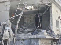 Civilians, paramedics, and Civil Defense Search and Rescue teams conduct search and rescue operations among the rubble of collapsed building...