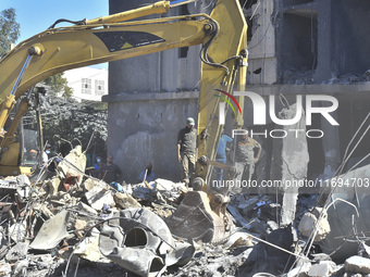 Civilians, paramedics, and Civil Defense Search and Rescue teams conduct search and rescue operations among the rubble of collapsed building...