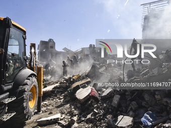 Civilians, paramedics, and Civil Defense Search and Rescue teams conduct search and rescue operations among the rubble of collapsed building...