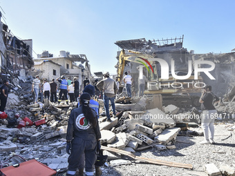 Civilians, paramedics, and Civil Defense Search and Rescue teams conduct search and rescue operations among the rubble of collapsed building...