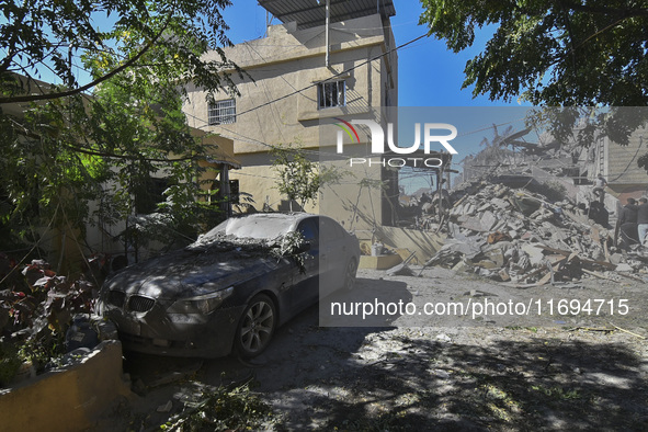 Civilians, paramedics, and Civil Defense Search and Rescue teams conduct search and rescue operations among the rubble of collapsed building...