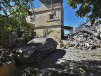 Civilians, paramedics, and Civil Defense Search and Rescue teams conduct search and rescue operations among the rubble of collapsed building...