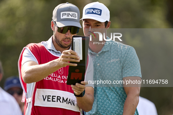 Johannes Veerman of the USA talks with his caddie on the 5th hole during day four of the Estrella Damm N.A. Andalucia Masters 2024 at Real C...