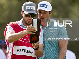 Johannes Veerman of the USA talks with his caddie on the 5th hole during day four of the Estrella Damm N.A. Andalucia Masters 2024 at Real C...