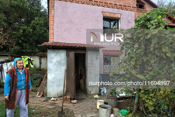 A woman stands outside a house damaged by the October 18 Russian missile strike in Odesa, Ukraine, on October 19, 2024. NO USE RUSSIA. NO US...