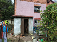 A woman stands outside a house damaged by the October 18 Russian missile strike in Odesa, Ukraine, on October 19, 2024. NO USE RUSSIA. NO US...