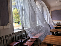 Curtains fly in a room damaged by the October 18 Russian missile strike in Odesa, Ukraine, on October 19, 2024. NO USE RUSSIA. NO USE BELARU...