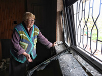 A woman stands by a smashed window after the October 18 Russian missile strike in Odesa, Ukraine, on October 19, 2024. NO USE RUSSIA. NO USE...