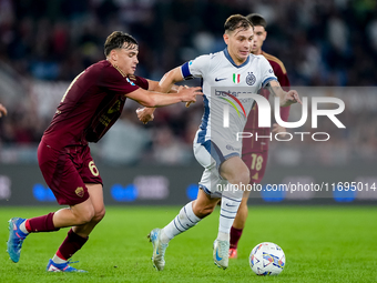 Nicolo' Barella of FC Internazionale and Niccolo' Pisilli of AS Roma compete for the ball during the Serie A Enilive match between AS Roma a...