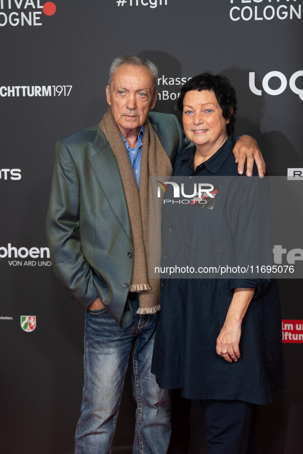 Udo Kier, a German actor, and Martina Richter, the director of the Cologne Film Festival, are seen on the red carpet during the photocall of...