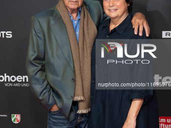 Udo Kier, a German actor, and Martina Richter, the director of the Cologne Film Festival, are seen on the red carpet during the photocall of...