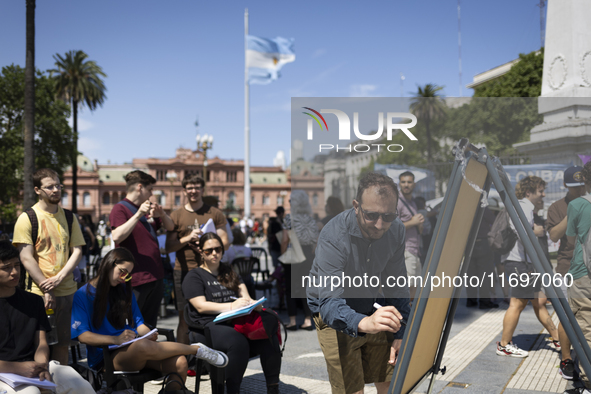 Students take a class outside the Casa Rosada presidential palace during a protest against a bill vetoed by Argentina's President Javier Mil...