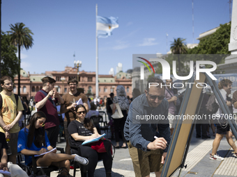 Students take a class outside the Casa Rosada presidential palace during a protest against a bill vetoed by Argentina's President Javier Mil...