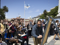 Students take a class outside the Casa Rosada presidential palace during a protest against a bill vetoed by Argentina's President Javier Mil...