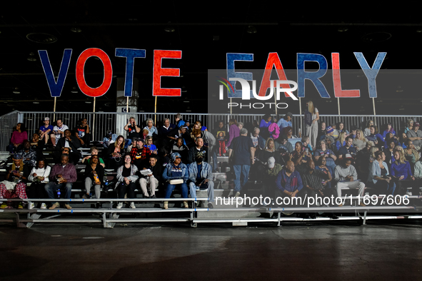 Attendees wait for former President Barack Obama to speak at a presidential campaign rally for Kamala Harris at The Huntington Place in Detr...