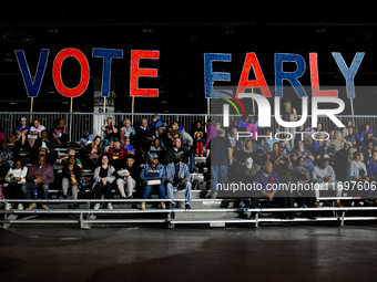 Attendees wait for former President Barack Obama to speak at a presidential campaign rally for Kamala Harris at The Huntington Place in Detr...