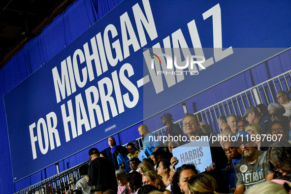 Attendees wait for former President Barack Obama to speak at a presidential campaign rally for Kamala Harris at The Huntington Place in Detr...