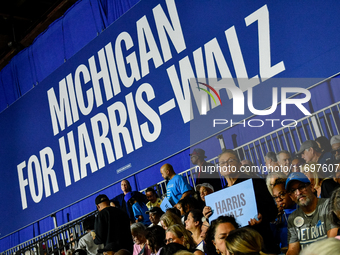 Attendees wait for former President Barack Obama to speak at a presidential campaign rally for Kamala Harris at The Huntington Place in Detr...