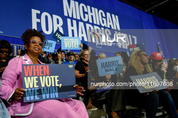 Attendees wait for former President Barack Obama to speak at a presidential campaign rally for Kamala Harris at The Huntington Place in Detr...