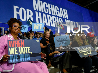 Attendees wait for former President Barack Obama to speak at a presidential campaign rally for Kamala Harris at The Huntington Place in Detr...