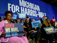 Attendees wait for former President Barack Obama to speak at a presidential campaign rally for Kamala Harris at The Huntington Place in Detr...