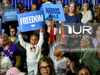 Attendees await former President Barack Obama to speak at a presidential campaign rally for Kamala Harris at The Huntington Place in Detroit...