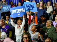 Attendees await former President Barack Obama to speak at a presidential campaign rally for Kamala Harris at The Huntington Place in Detroit...