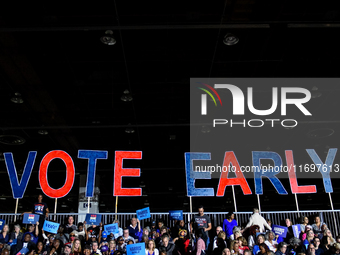 Attendees await former President Barack Obama to speak at a presidential campaign rally for Kamala Harris at The Huntington Place in Detroit...