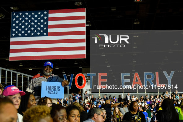 T. Couch, 66, in Detroit, MI, on October 22, 2024, holds up a Kamala Harris campaign sign while awaiting former President Barack Obama to sp...