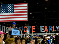 T. Couch, 66, in Detroit, MI, on October 22, 2024, holds up a Kamala Harris campaign sign while awaiting former President Barack Obama to sp...