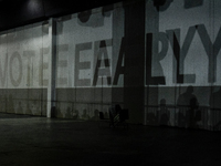 A shadow stating ''Vote Early'' is cast upon the back wall of The Huntington Place before former President Barack Obama speaks at a presiden...