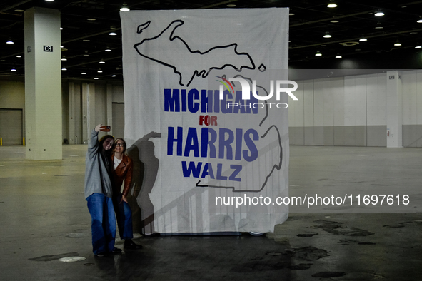 Attendees take a selfie together while awaiting former President Barack Obama to speak at a presidential campaign rally for Kamala Harris at...