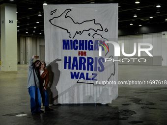 Attendees take a selfie together while awaiting former President Barack Obama to speak at a presidential campaign rally for Kamala Harris at...