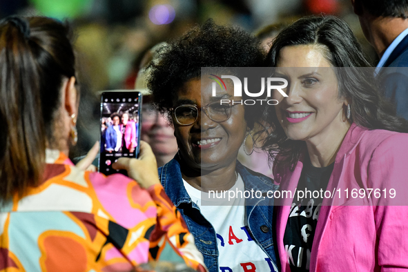 Michigan Governor Gretchen Whitmer pauses to take a photo with an attendee during a presidential campaign rally for Kamala Harris at The Hun...