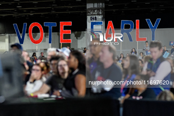 Attendees wait for former President Barack Obama to speak at a presidential campaign rally for Kamala Harris at The Huntington Place in Detr...