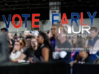 Attendees wait for former President Barack Obama to speak at a presidential campaign rally for Kamala Harris at The Huntington Place in Detr...