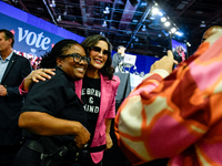 Michigan Governor Gretchen Whitmer pauses to take a photo with a Detroit Police officer during a presidential campaign rally for Kamala Harr...