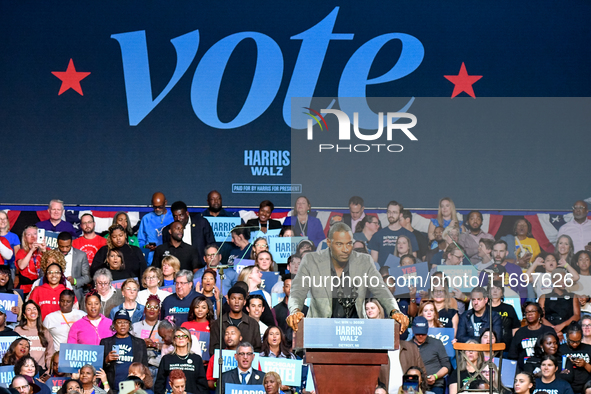 Former Detroit Lions wide receiver Calvin Johnson speaks during a presidential campaign rally for Kamala Harris at The Huntington Place in D...