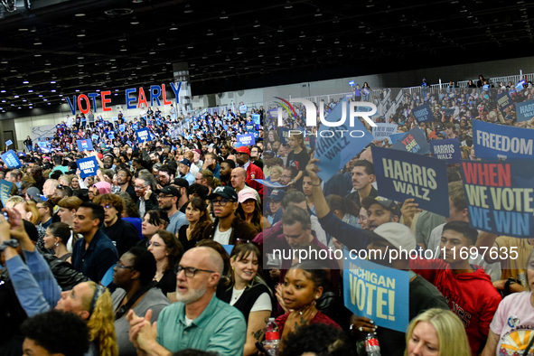 Attendees wait for former President Barack Obama to speak at a presidential campaign rally for Kamala Harris at The Huntington Place in Detr...