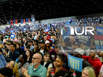 Attendees wait for former President Barack Obama to speak at a presidential campaign rally for Kamala Harris at The Huntington Place in Detr...