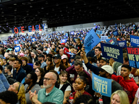 Attendees wait for former President Barack Obama to speak at a presidential campaign rally for Kamala Harris at The Huntington Place in Detr...