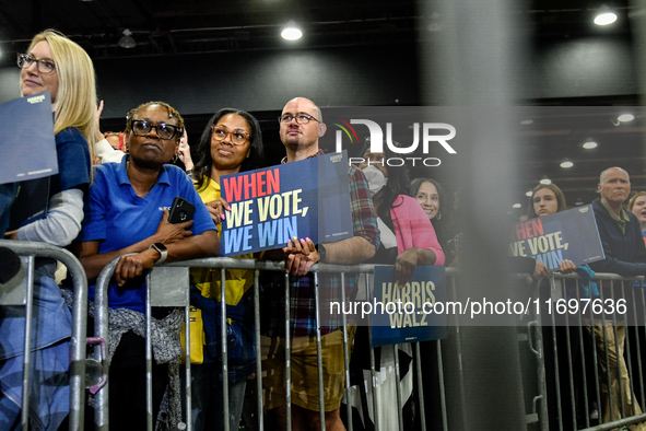 Attendees wait for former President Barack Obama to speak at a presidential campaign rally for Kamala Harris at The Huntington Place in Detr...