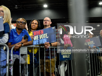 Attendees wait for former President Barack Obama to speak at a presidential campaign rally for Kamala Harris at The Huntington Place in Detr...