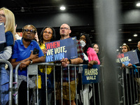 Attendees wait for former President Barack Obama to speak at a presidential campaign rally for Kamala Harris at The Huntington Place in Detr...