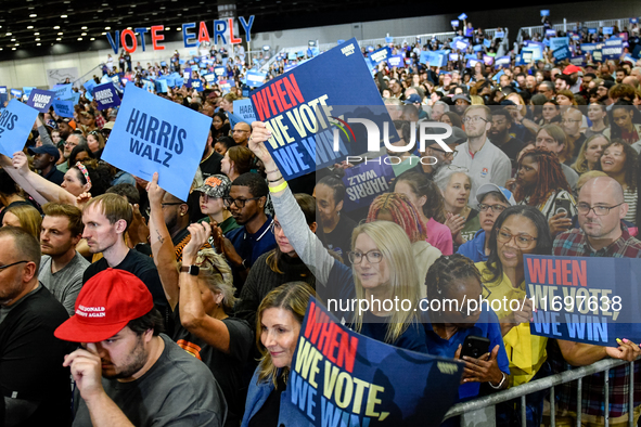 Attendees wait for former President Barack Obama to speak at a presidential campaign rally for Kamala Harris at The Huntington Place in Detr...