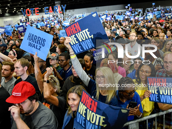 Attendees wait for former President Barack Obama to speak at a presidential campaign rally for Kamala Harris at The Huntington Place in Detr...