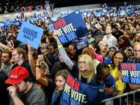 Attendees wait for former President Barack Obama to speak at a presidential campaign rally for Kamala Harris at The Huntington Place in Detr...