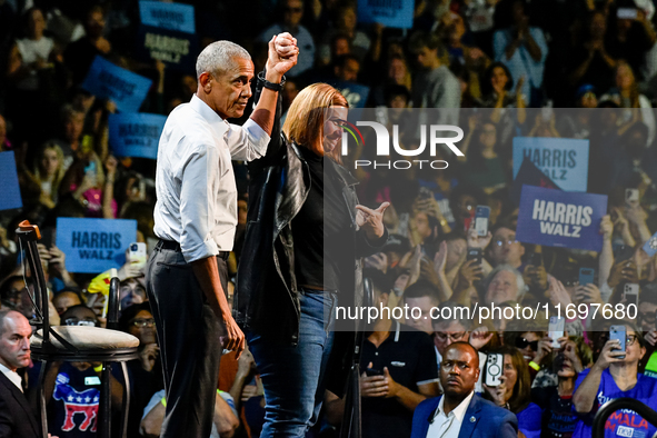 Former President Barack Obama raises the hand of U.S. Senate candidate Elissa Slotkin (D-MI) at a presidential campaign rally for Kamala Har...