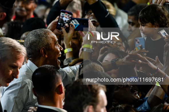 Former President Barack Obama shakes the hands of attendees at the conclusion of a presidential campaign rally for Kamala Harris at The Hunt...